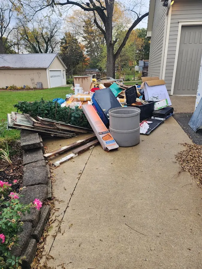 Dumpster being loaded with debris for 12 Yard Dumpster Rental in Selma